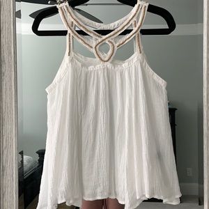 White sleeveless top with beaded detail